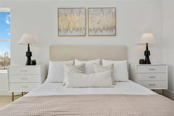 a large white bed in a white room