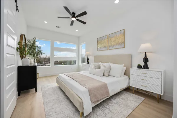a bedroom with a large bed and a window