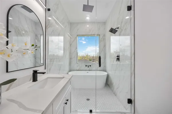 a bathroom with a double vanity sink mirror and shower