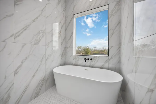 a bathroom with a bathtub and a shower