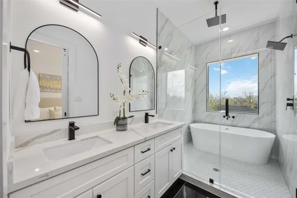 a bathroom with double vanity sinks and a mirror