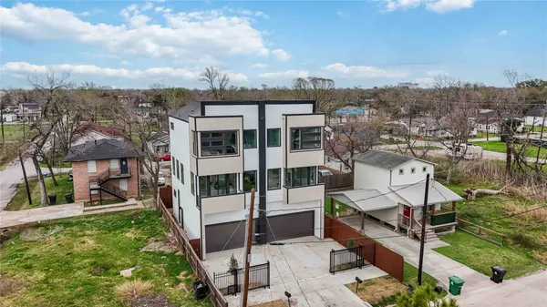 an aerial view of a house with a yard