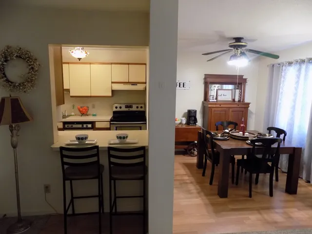 a view of a dining room with furniture and chandelier