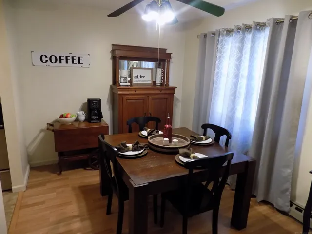 a view of a dining room with furniture and window