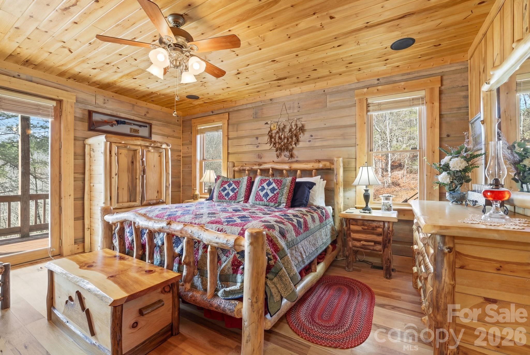 2150 Shell Stand Road Almond, NC 28702 - Photo 20 of 42 a bedroom with a bed and a chandelier