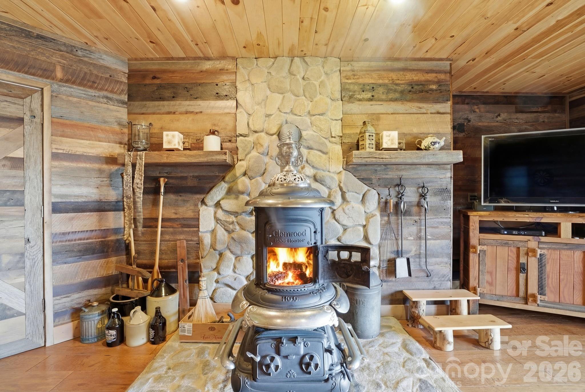 2150 Shell Stand Road Almond, NC 28702 - Photo 32 of 42 a living room with fireplace furniture and a flat screen tv