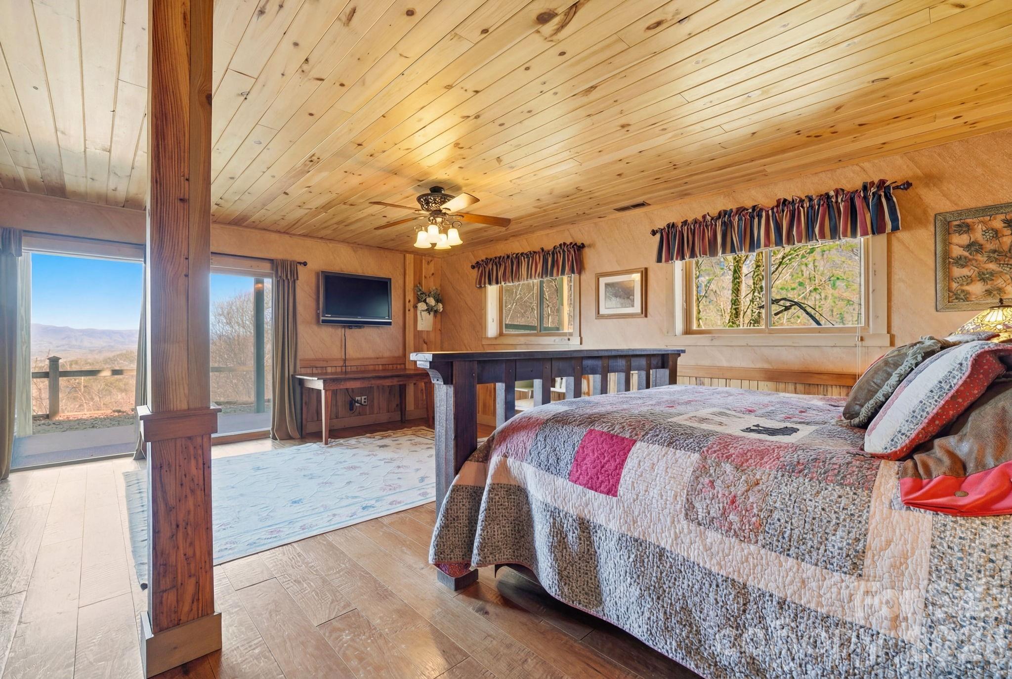 2150 Shell Stand Road Almond, NC 28702 - Photo 33 of 42 a bedroom with a bed window and a flat screen tv