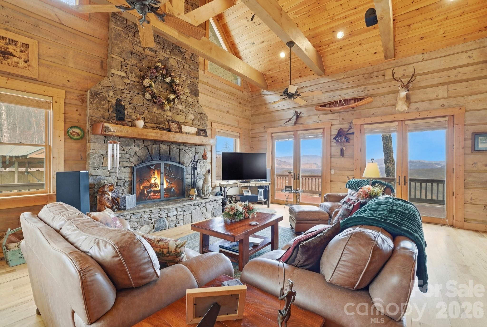 2150 Shell Stand Road Almond, NC 28702 - Photo 5 of 42 a living room with furniture fireplace and a flat screen tv