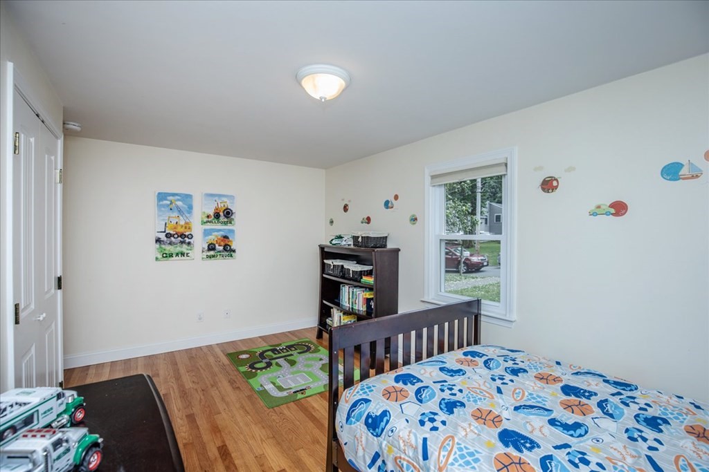 22 Lantern Lane Burlington, MA 01803 - Photo 24 of 34 a bedroom with furniture and a book shelf