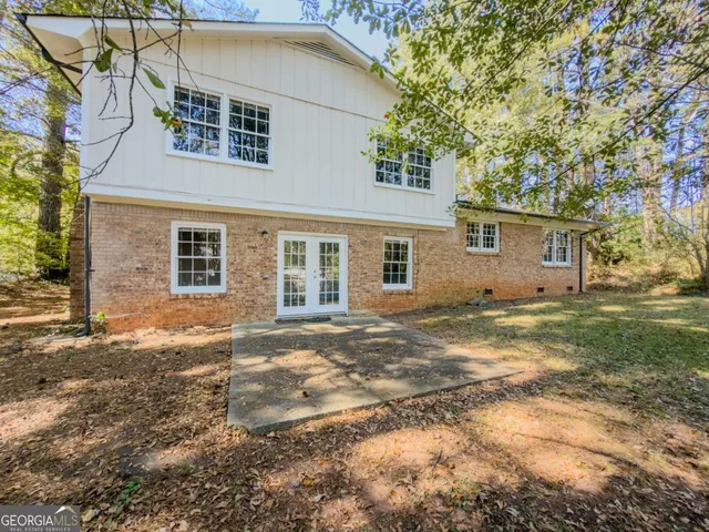 a view of a yard in front of a house with a large tree