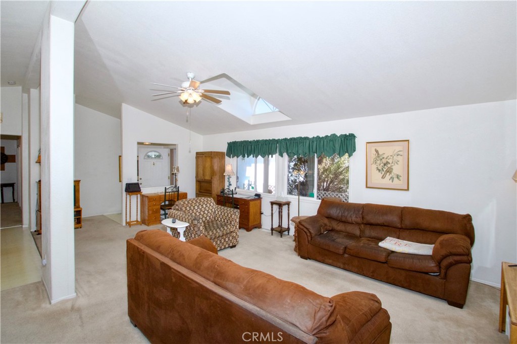 4742 Avenida La Mirada Joshua Tree, CA 92252 - Photo 11 of 45 a living room with furniture ceiling fan and a window