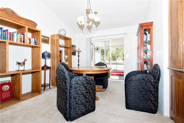 a living room with furniture a large window and a chandelier