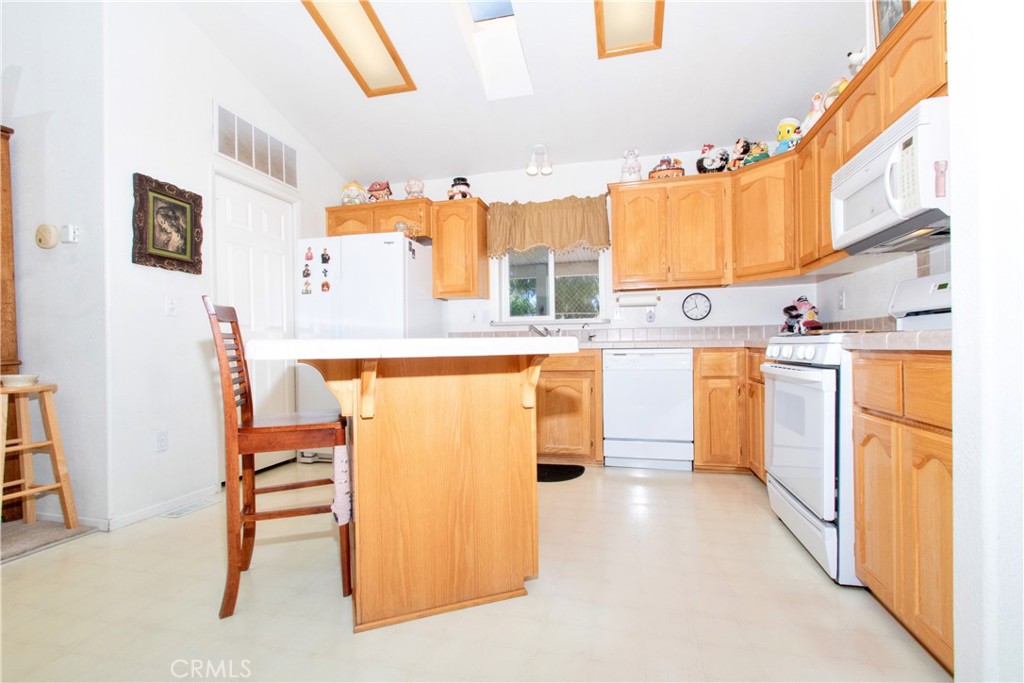 4742 Avenida La Mirada Joshua Tree, CA 92252 - Photo 16 of 45 a kitchen with stainless steel appliances a refrigerator and a stove