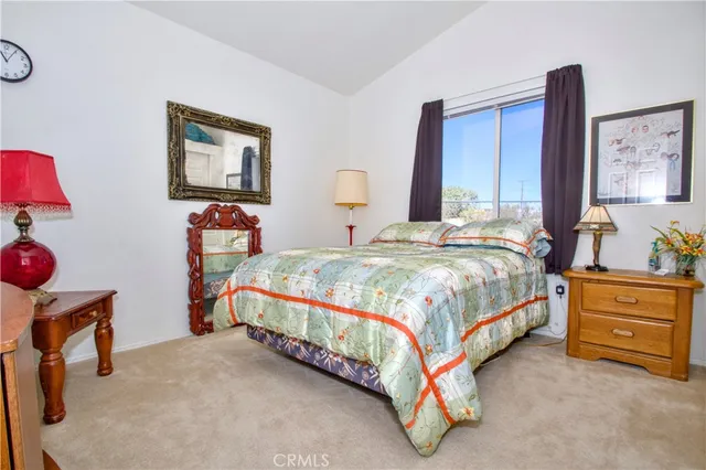 a bedroom with bed and a chandelier
