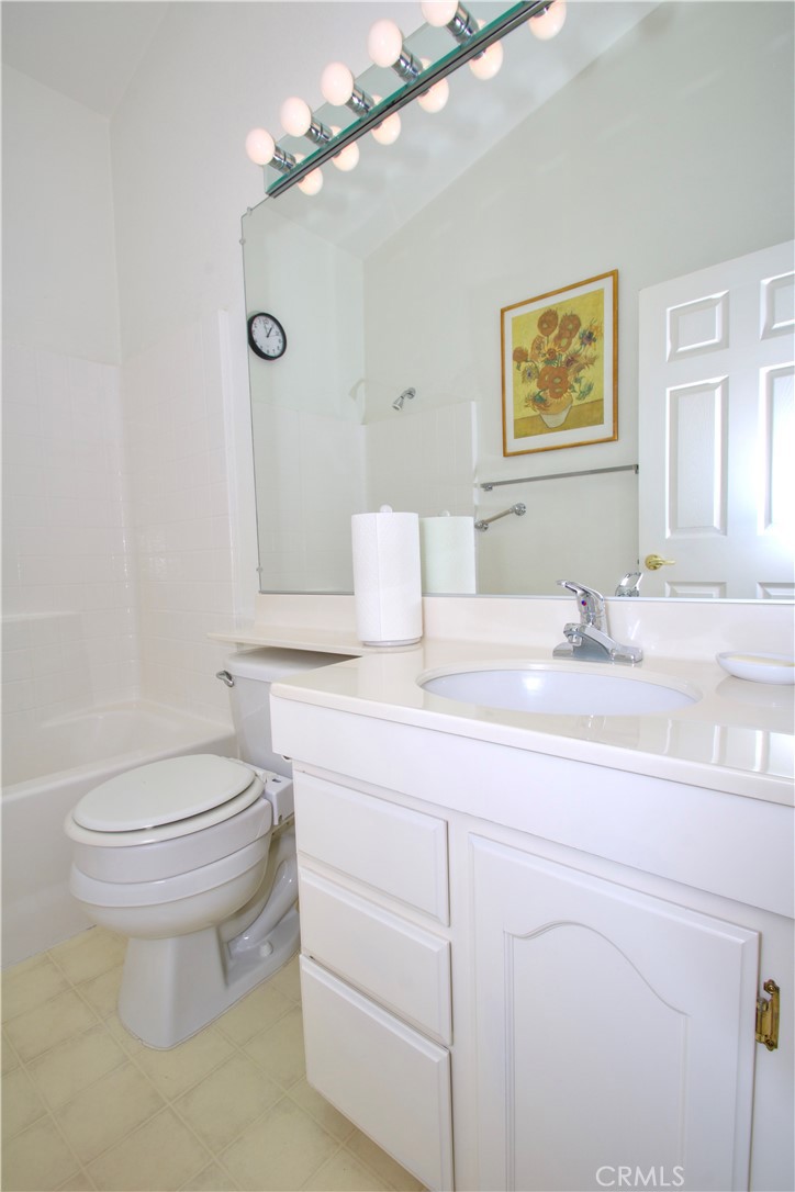 4742 Avenida La Mirada Joshua Tree, CA 92252 - Photo 23 of 45 a bathroom with a granite countertop toilet sink and mirror