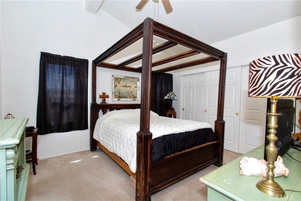 4742 Avenida La Mirada Joshua Tree, CA 92252 - Photo 24 of 45 a bed room with a bed and a mirror