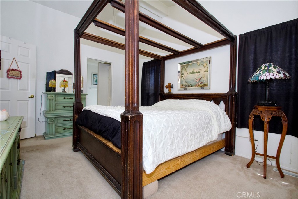 4742 Avenida La Mirada Joshua Tree, CA 92252 - Photo 25 of 45 a bed room with a bed and a window