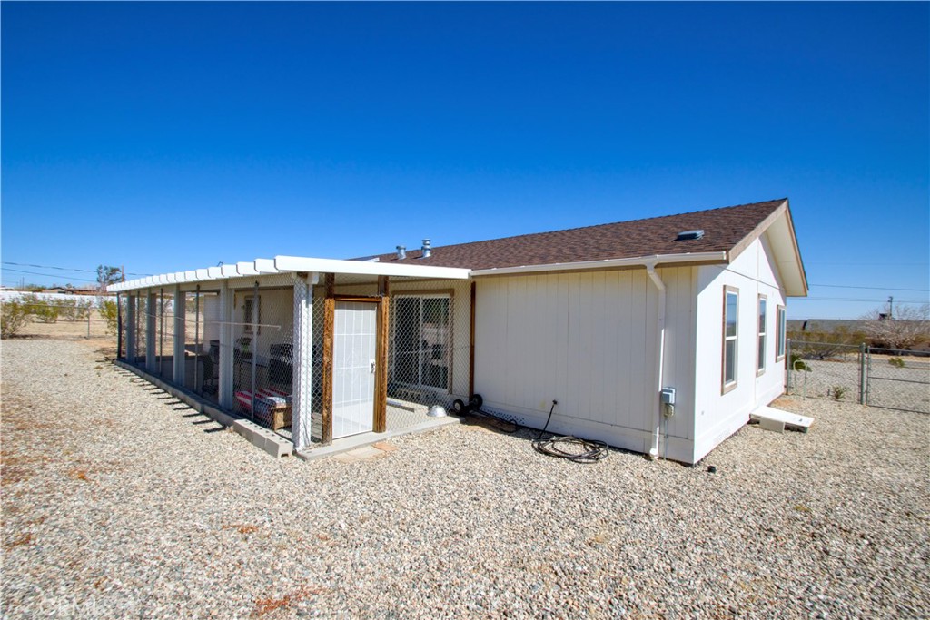 4742 Avenida La Mirada Joshua Tree, CA 92252 - Photo 31 of 45 a view of a house with a backyard