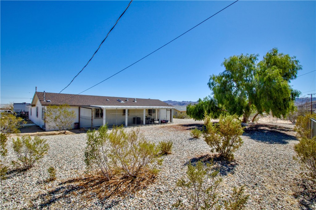 4742 Avenida La Mirada Joshua Tree, CA 92252 - Photo 32 of 45 a view of a house with a yard