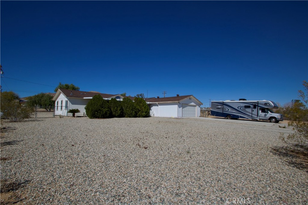 4742 Avenida La Mirada Joshua Tree, CA 92252 - Photo 6 of 45 a view of a street with a building in the background