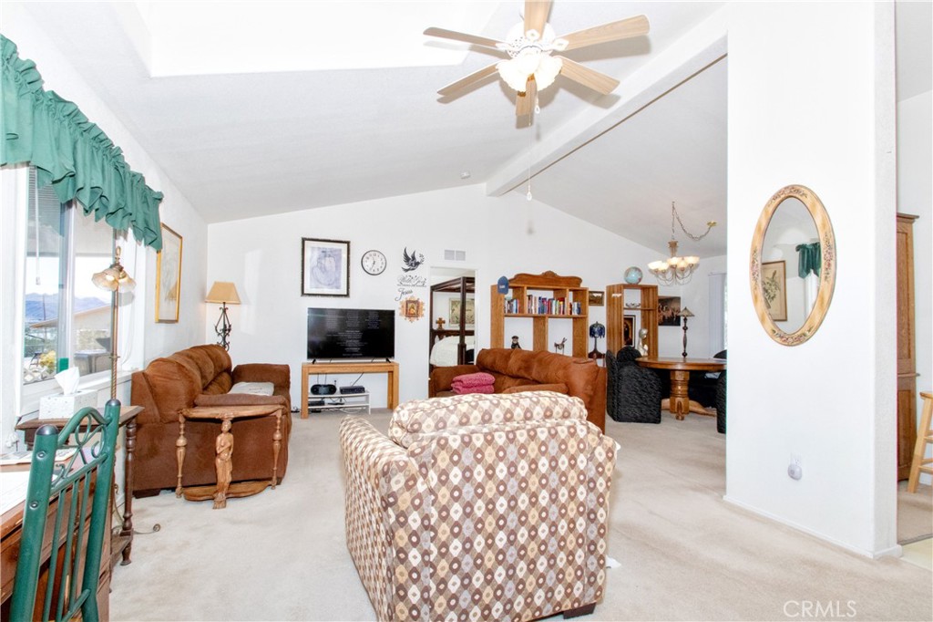 4742 Avenida La Mirada Joshua Tree, CA 92252 - Photo 10 of 45 a living room with furniture a flat screen tv and a large window