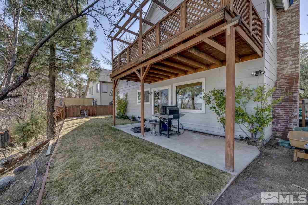 3812 Bexley Square Reno, NV 89503 - Photo 15 of 16 a view of a backyard with table and chairs and a large tree