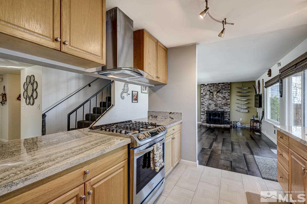 3812 Bexley Square Reno, NV 89503 - Photo 2 of 16 a kitchen with stainless steel appliances granite countertop a stove a sink and a refrigerator