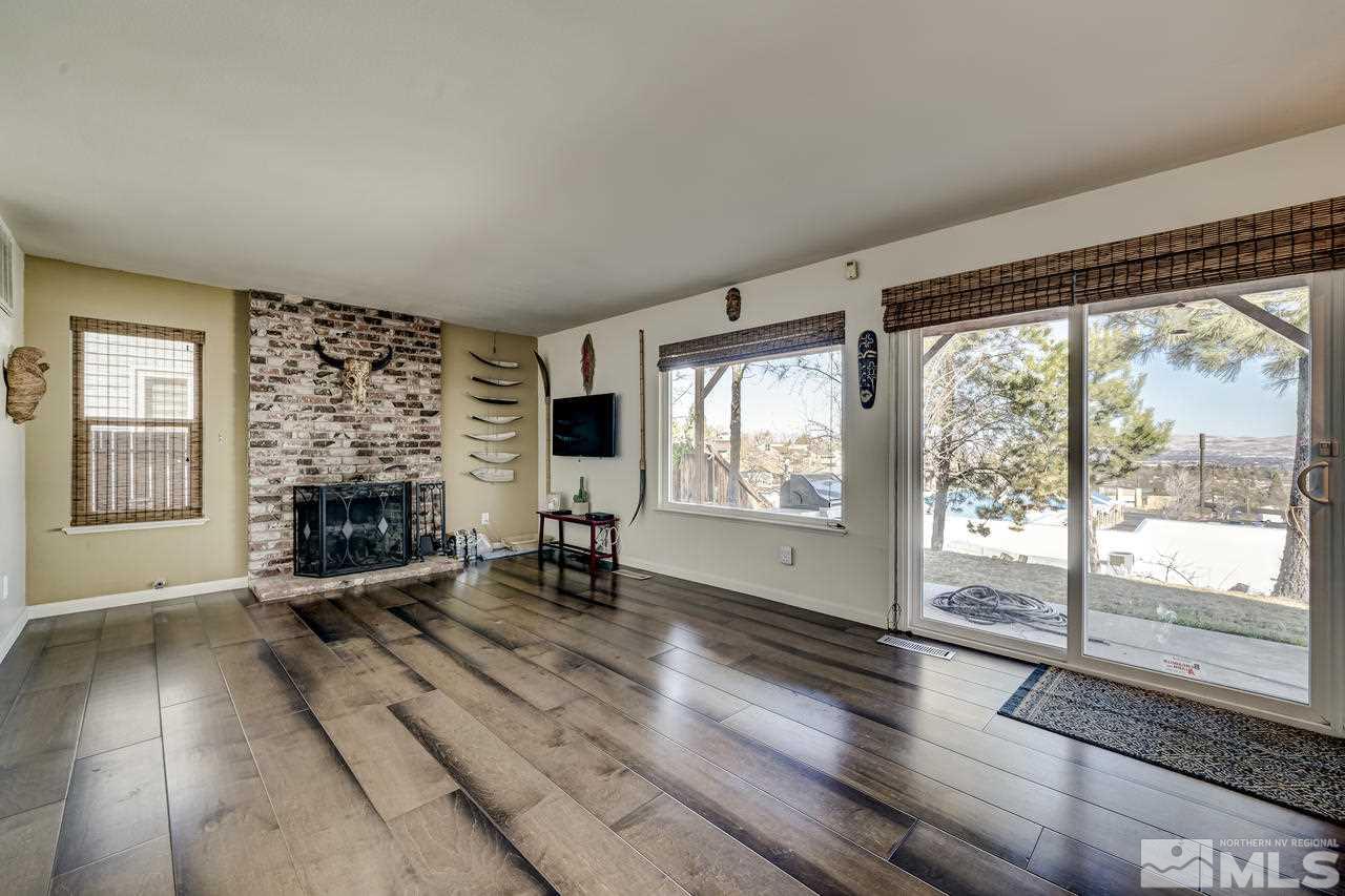 3812 Bexley Square Reno, NV 89503 - Photo 7 of 16 a living room with furniture large window and a fireplace