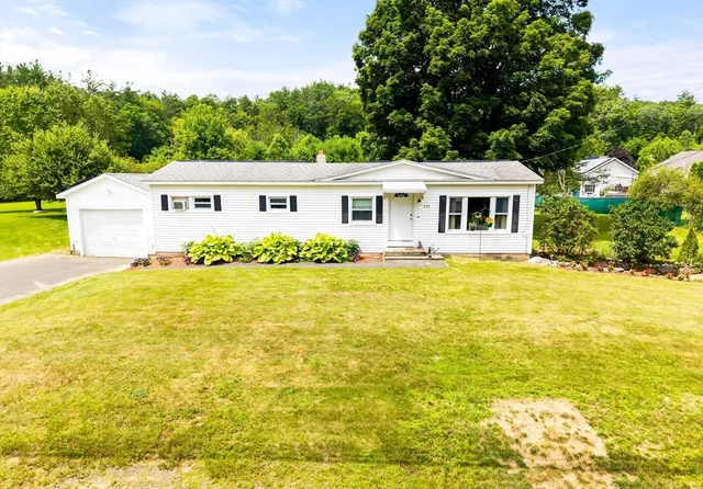 a front view of house with yard and green space