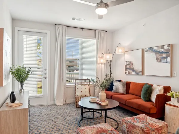 a living room with furniture and a potted plant
