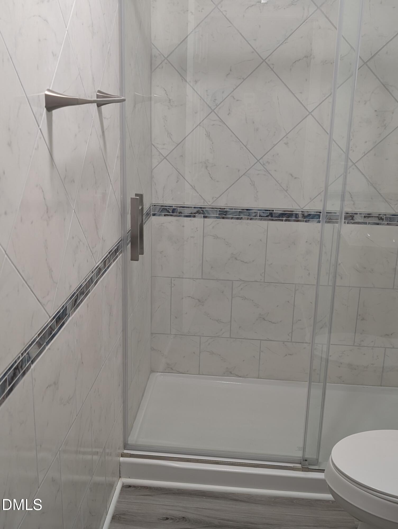 1005 Shades Place Raleigh, NC 27601 - Photo 14 of 18 a bathroom with a shower and toilet