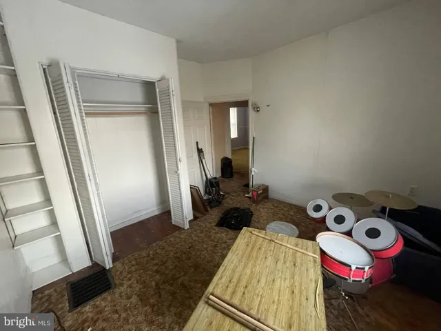 a bedroom with a bed and a mirror