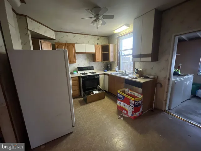 a kitchen with refrigerator and stove