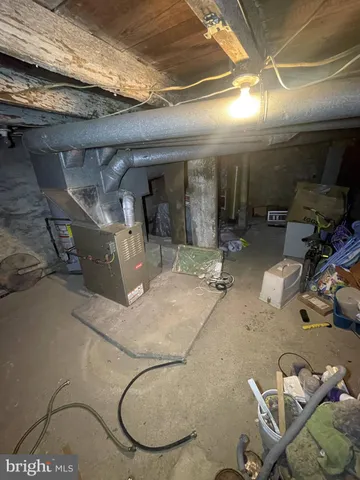 a room with water heater and wooden walls