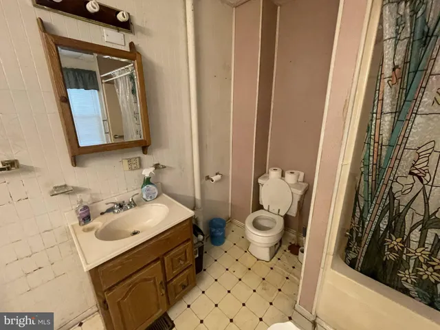a bathroom with a sink mirror and toilet