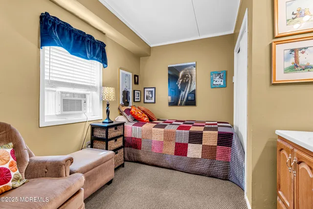 a spacious bedroom with a bed and a chandelier