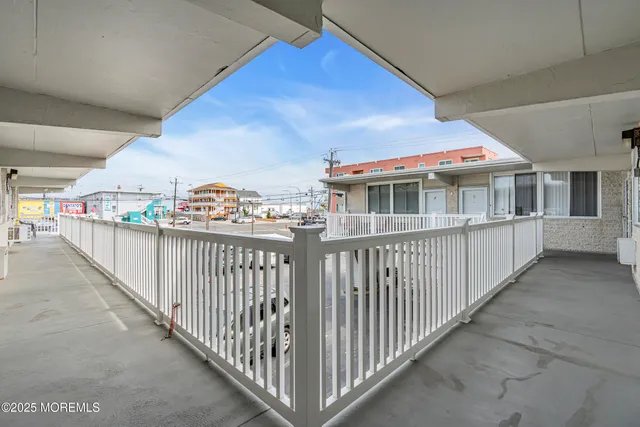 a living room with furniture a rug and white walls