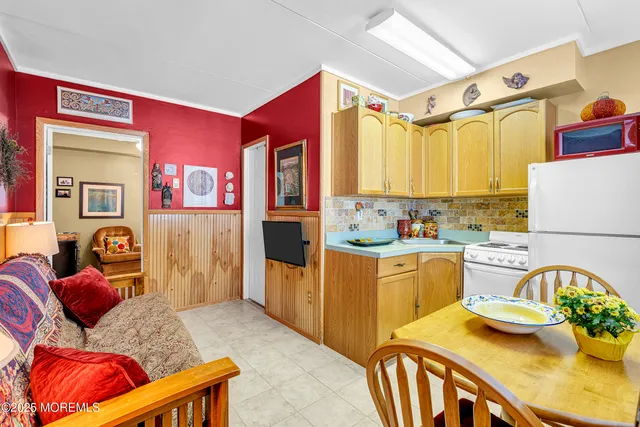 a kitchen with a refrigerator and a stove top oven