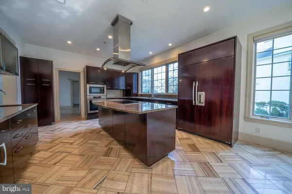 a view of a kitchen with a sink outdoor counter top space and stainless steel appliances
