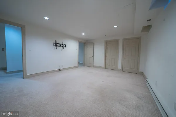 a view of an empty room with a cabinet and a window