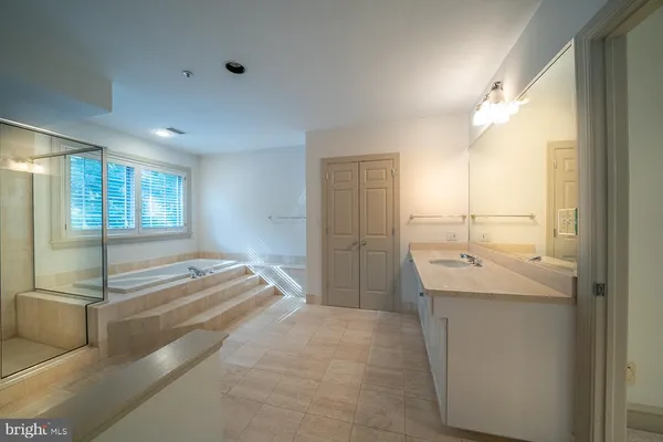 a spacious bathroom with double sink and mirror