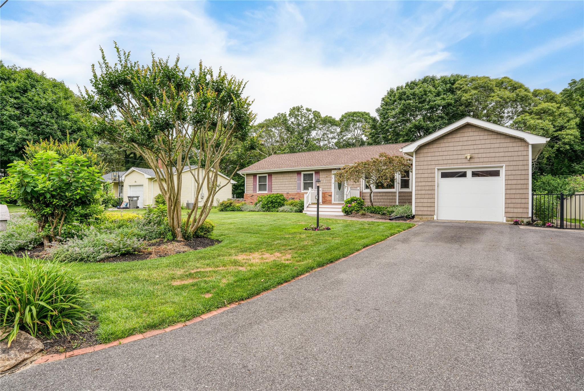 Ranch-style house with a garage and driveway