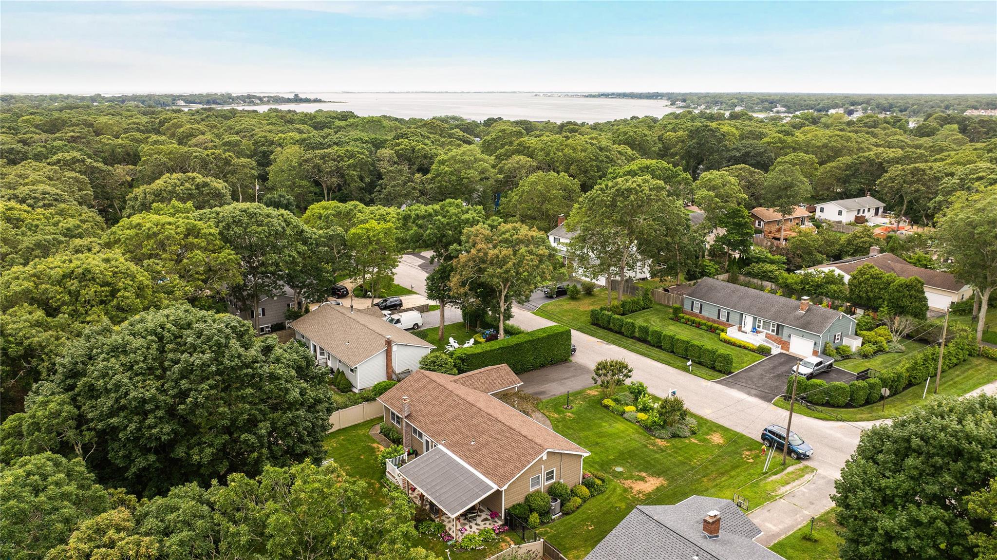 7 Russell Road Hampton Bays, NY 11946 - Photo 13 of 31 Aerial view of residential area with a nearby body of water and a forest