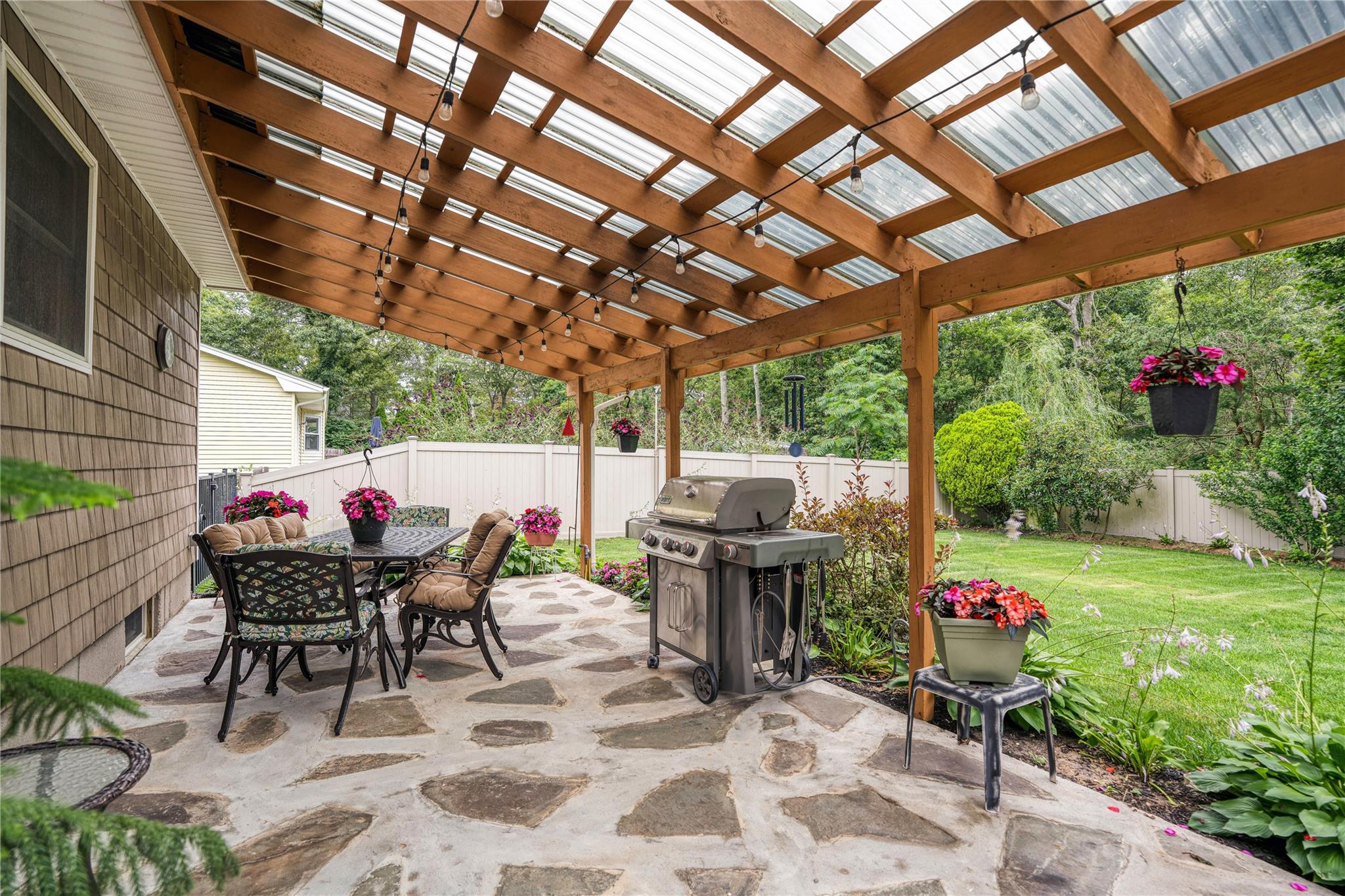 7 Russell Road Hampton Bays, NY 11946 - Photo 18 of 31 Fenced backyard with a grill, a patio, outdoor dining space, and a pergola