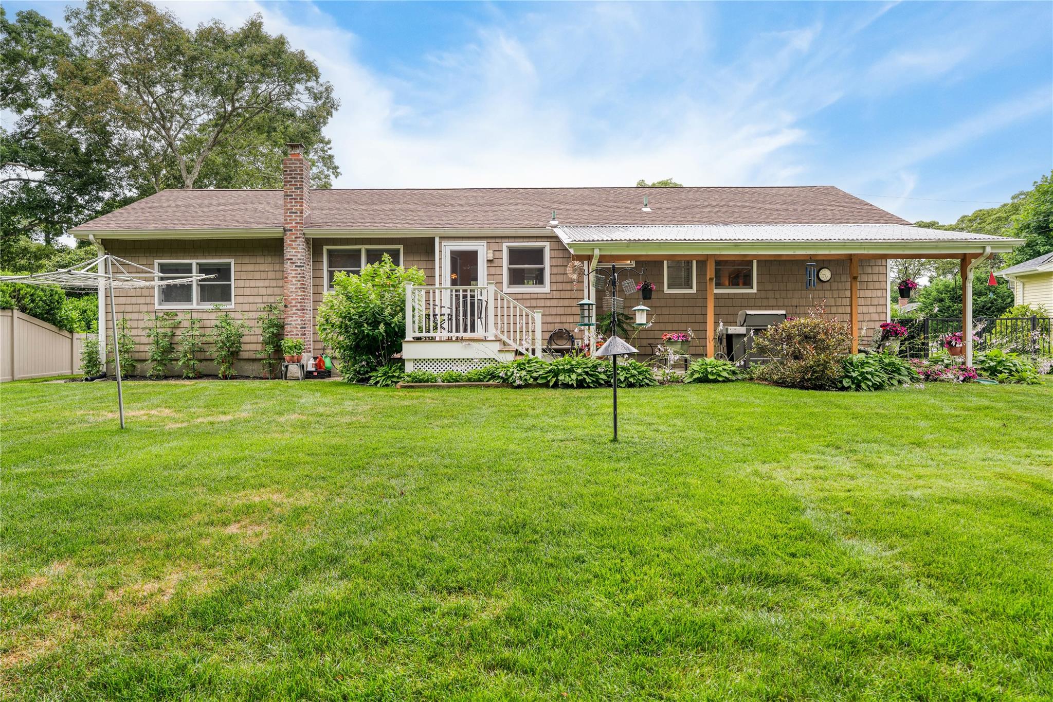 7 Russell Road Hampton Bays, NY 11946 - Photo 22 of 31 Rear view of property featuring a shingled roof and a chimney