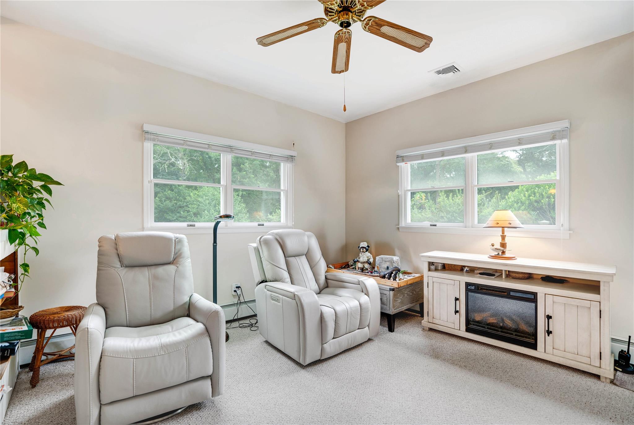 7 Russell Road Hampton Bays, NY 11946 - Photo 24 of 31 Living area with a ceiling fan, baseboard heating, and light colored carpet