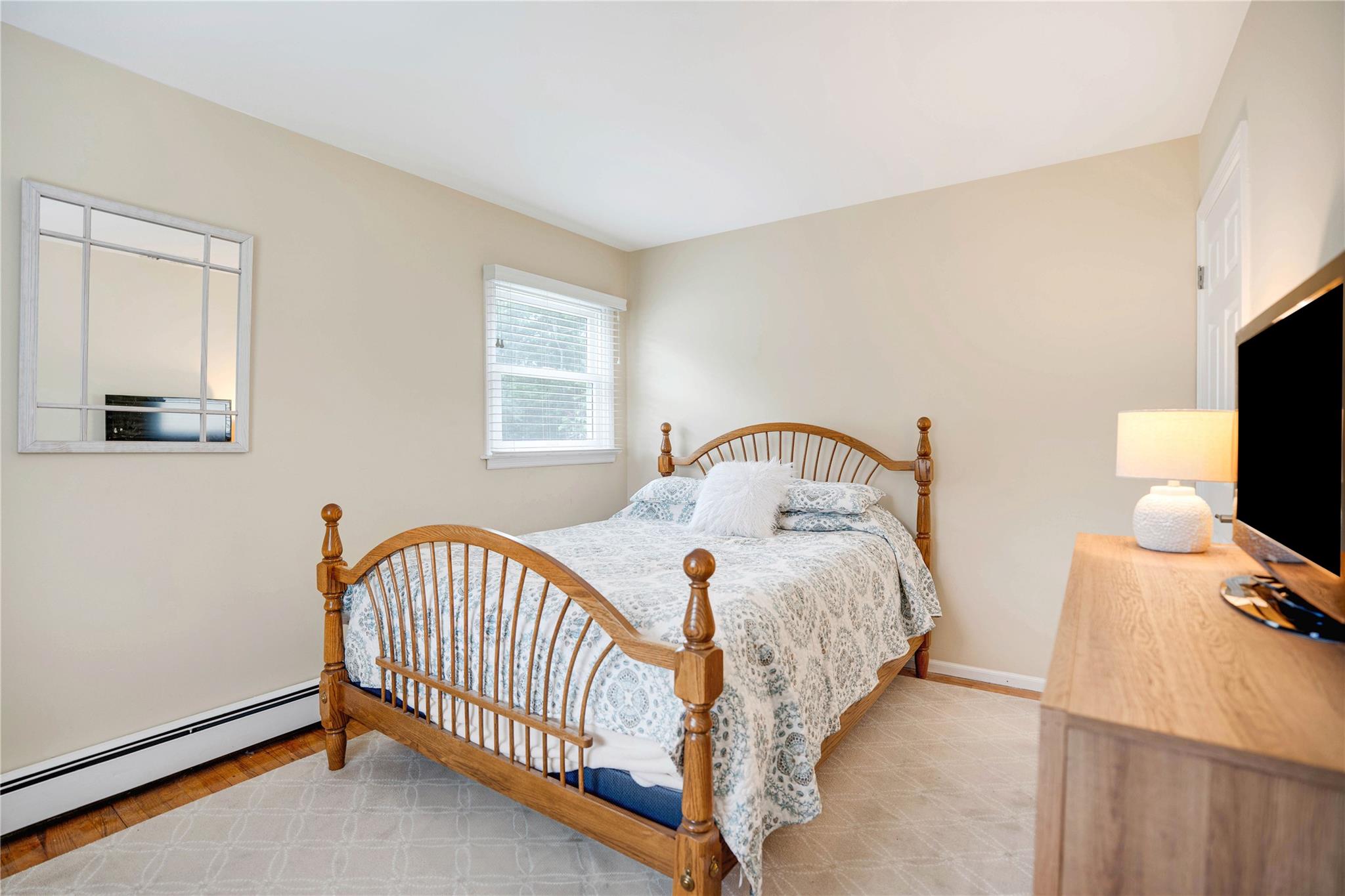 7 Russell Road Hampton Bays, NY 11946 - Photo 8 of 31 Bedroom with baseboard heating and baseboards