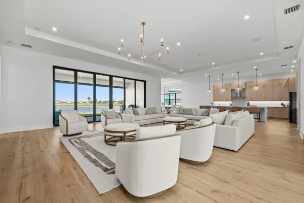 a living room with a bed furniture and next to a window