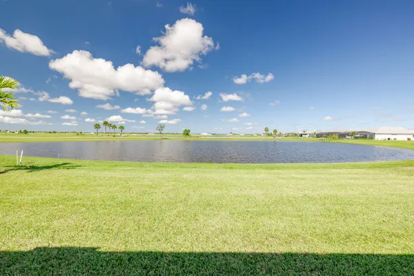 a large white kitchen with lots of counter space and refrigerator