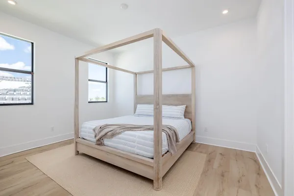 an aerial view of a pool lawn chairs and a fire pit